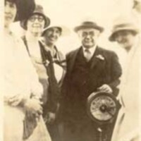 C.L. Abernethy and four women beside the engine order telegraph aboard the United States Coast Guard Cutter Pamlico.