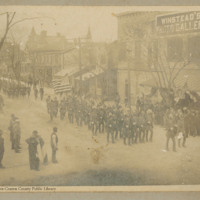 Soldiers marching in front of Winstead&#039;s Photo Gallery, looking west on Pollock Street near the corner of Middle Street.