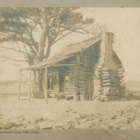 Log cabin with stick and mud chimney
